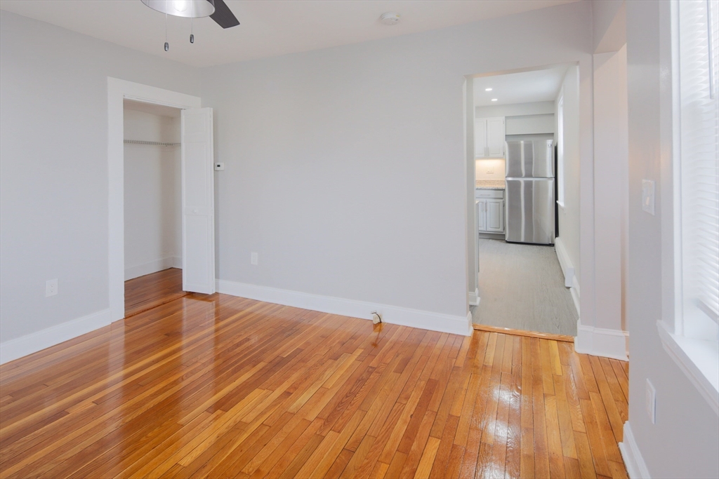 259 Calvary Street, Unit 1 Waltham, MA 02453 - Photo 16 of 27 a view of empty room with wooden floor