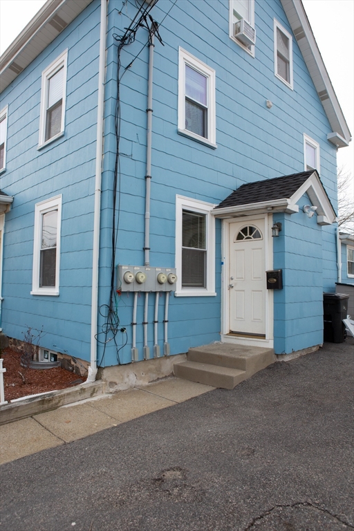 259 Calvary Street, Unit 1 Waltham, MA 02453 - Photo 27 of 27 a front view of a house with a garage