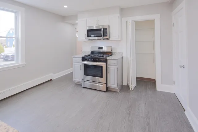 a kitchen with stainless steel appliances a stove a microwave and a refrigerator