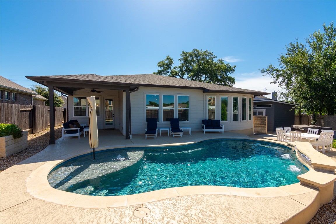 a view of a house with swimming pool and sitting area