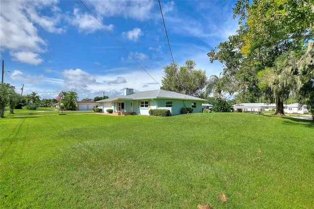 swimming pool view with a garden and trees
