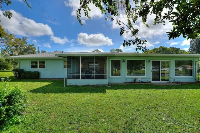 an aerial view of a house with garden space and street view