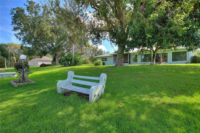an aerial view of a house with a backyard