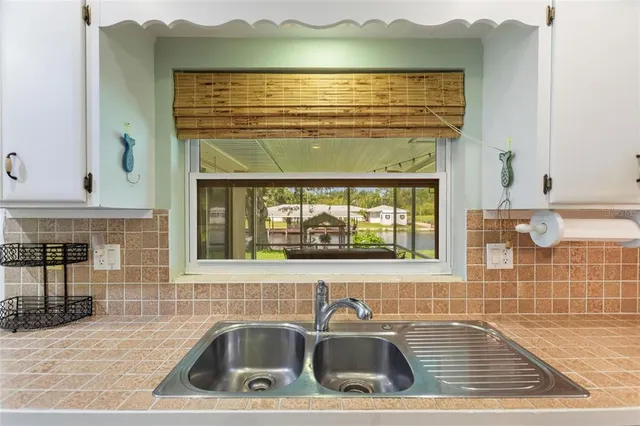 a view of a livingroom with furniture and a kitchen