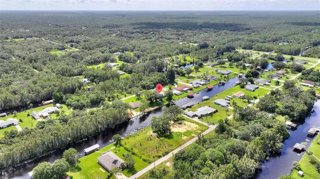 a view of a lake with a house in a yard