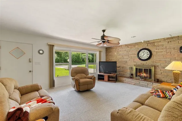 a kitchen with stainless steel appliances kitchen island granite countertop a refrigerator and a stove