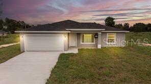 151 Malauka Road Ocklawaha, FL 32179 - Photo 1 of 29 a front view of a house with a yard and lake view