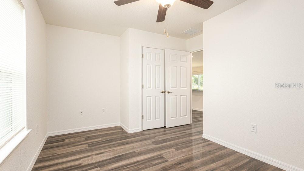 151 Malauka Road Ocklawaha, FL 32179 - Photo 18 of 29 a view of an empty room with wooden floor ceiling fan