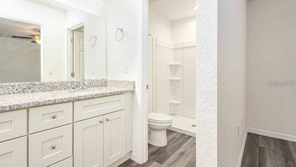 151 Malauka Road Ocklawaha, FL 32179 - Photo 25 of 29 a bathroom with a granite countertop sink toilet and shower