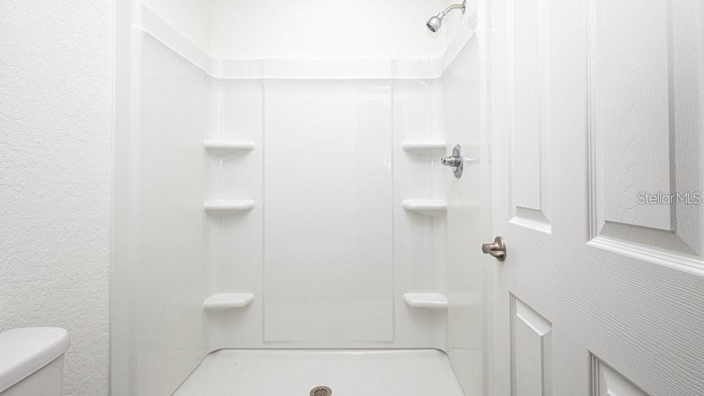 151 Malauka Road Ocklawaha, FL 32179 - Photo 26 of 29 a bathroom with a shower a toilet and sink