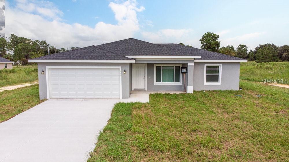 151 Malauka Road Ocklawaha, FL 32179 - Photo 5 of 29 a front view of a house with garden