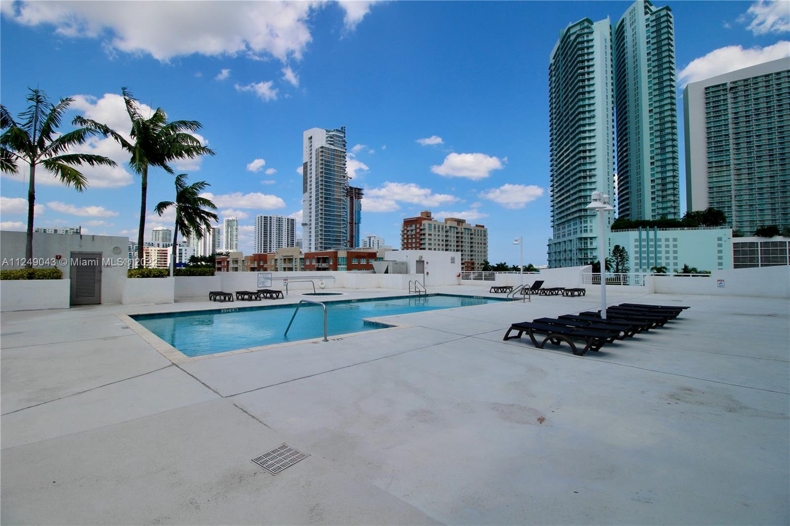 275 Northeast 18th Street, Unit 306 Miami, FL 33132 - Photo 11 of 15 a swimming pool with outdoor seating and yard