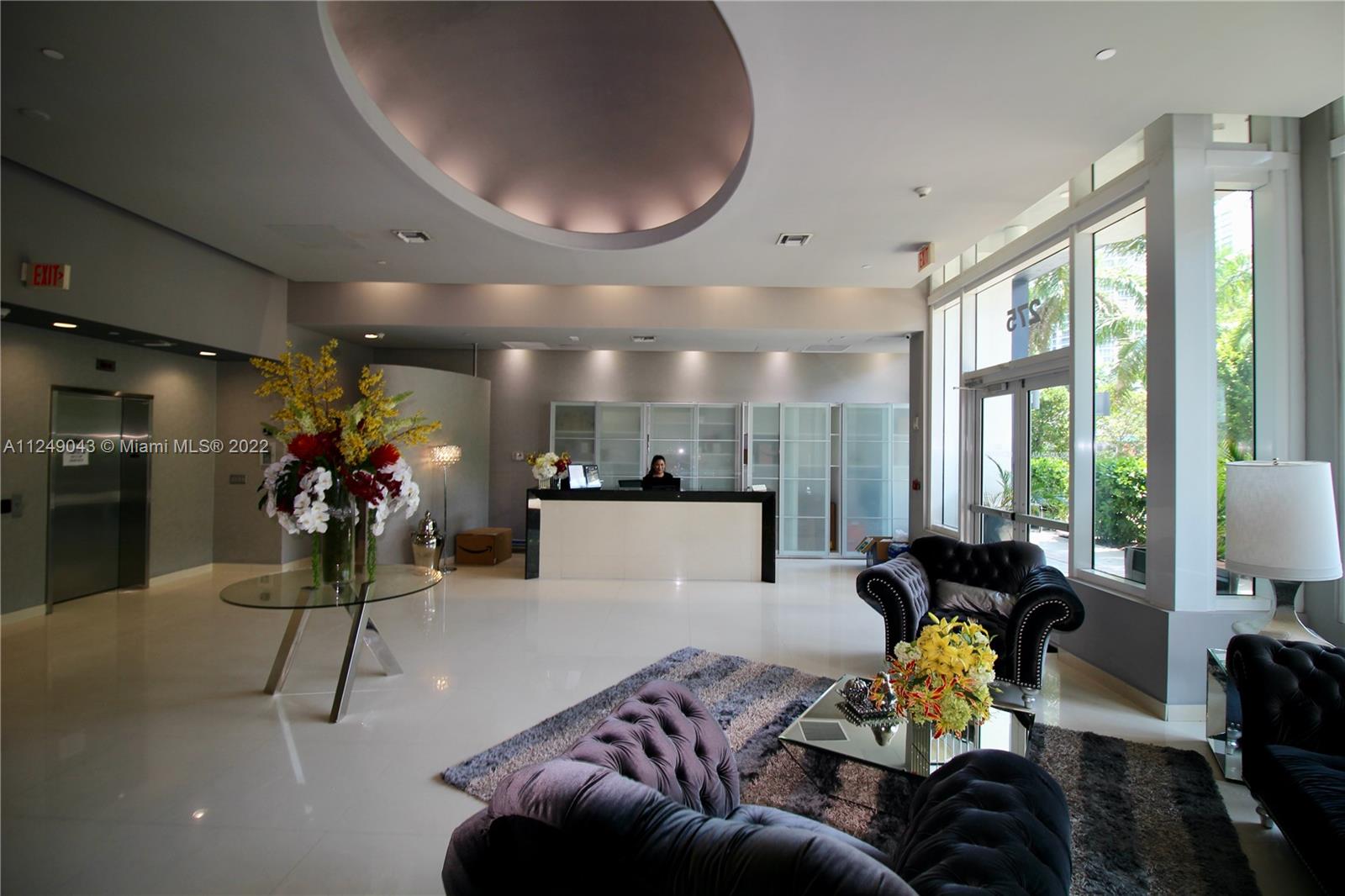 275 Northeast 18th Street, Unit 306 Miami, FL 33132 - Photo 13 of 15 a living room with furniture and a large window