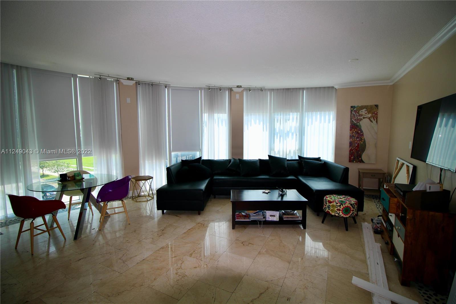 275 Northeast 18th Street, Unit 306 Miami, FL 33132 - Photo 3 of 15 a living room with furniture and a large window