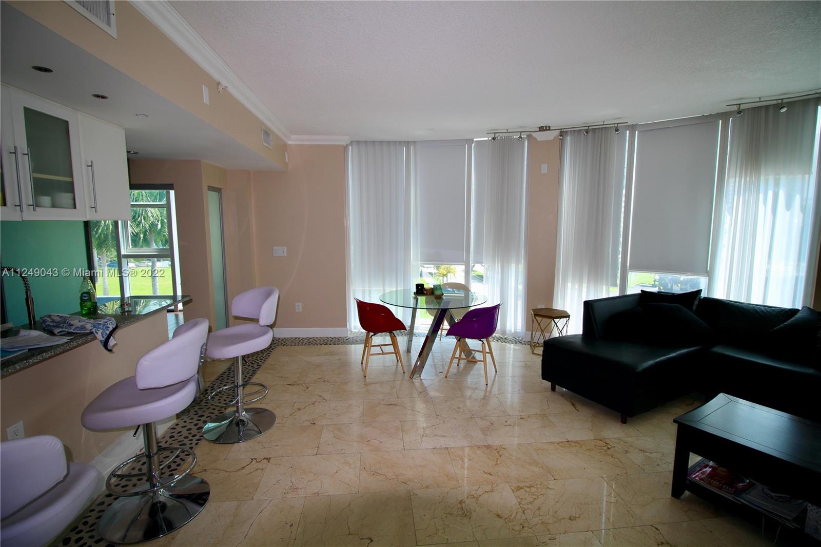 275 Northeast 18th Street, Unit 306 Miami, FL 33132 - Photo 4 of 15 a living room with furniture and a window