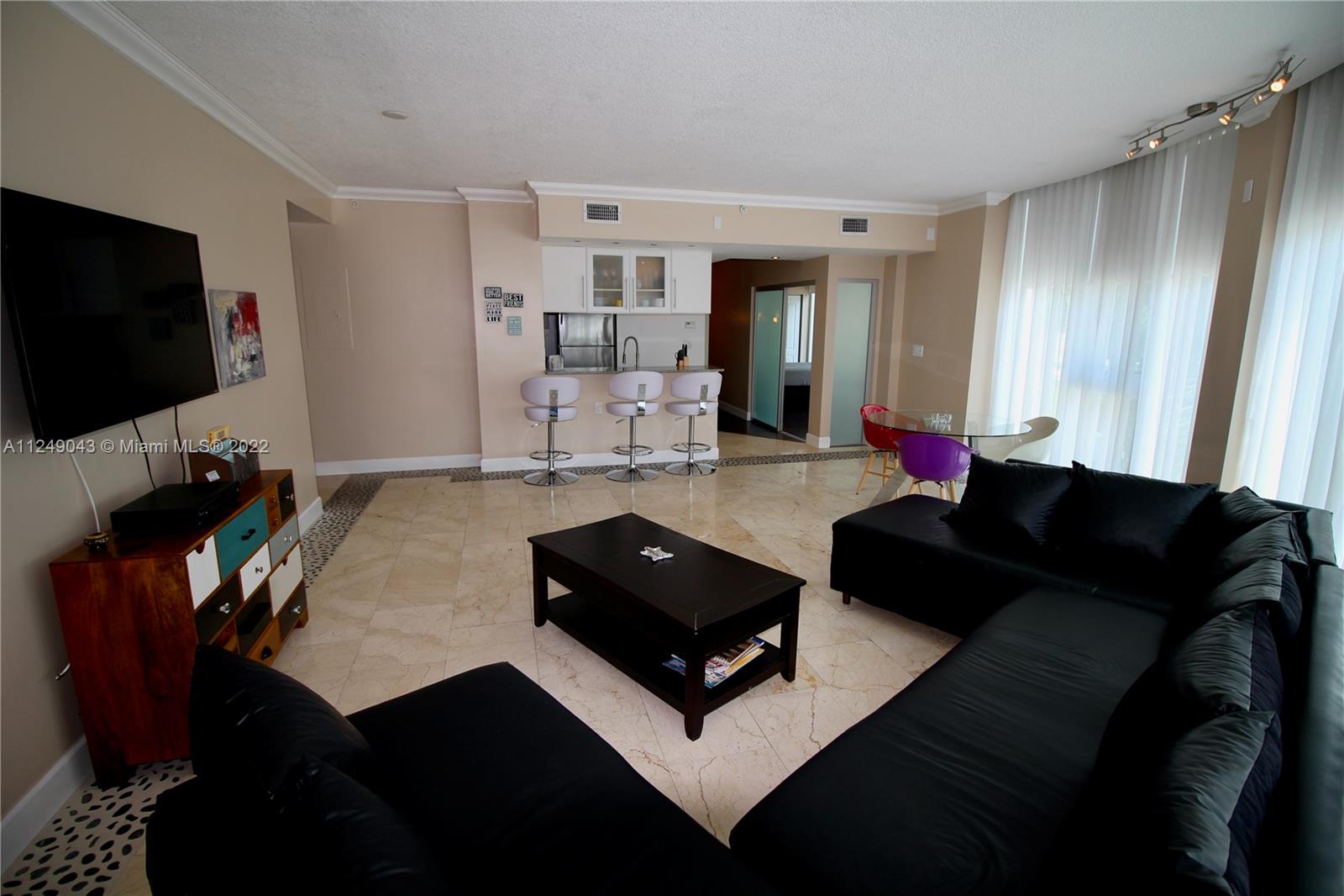 275 Northeast 18th Street, Unit 306 Miami, FL 33132 - Photo 6 of 15 a living room with furniture and a flat screen tv