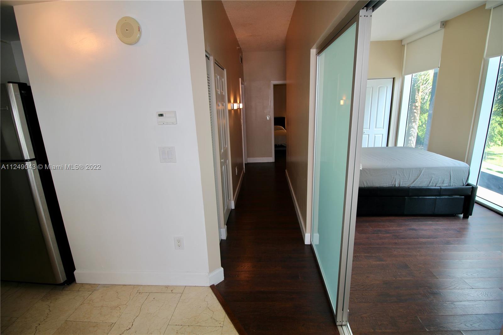 275 Northeast 18th Street, Unit 306 Miami, FL 33132 - Photo 8 of 15 a view of a hallway to a bedroom and front door