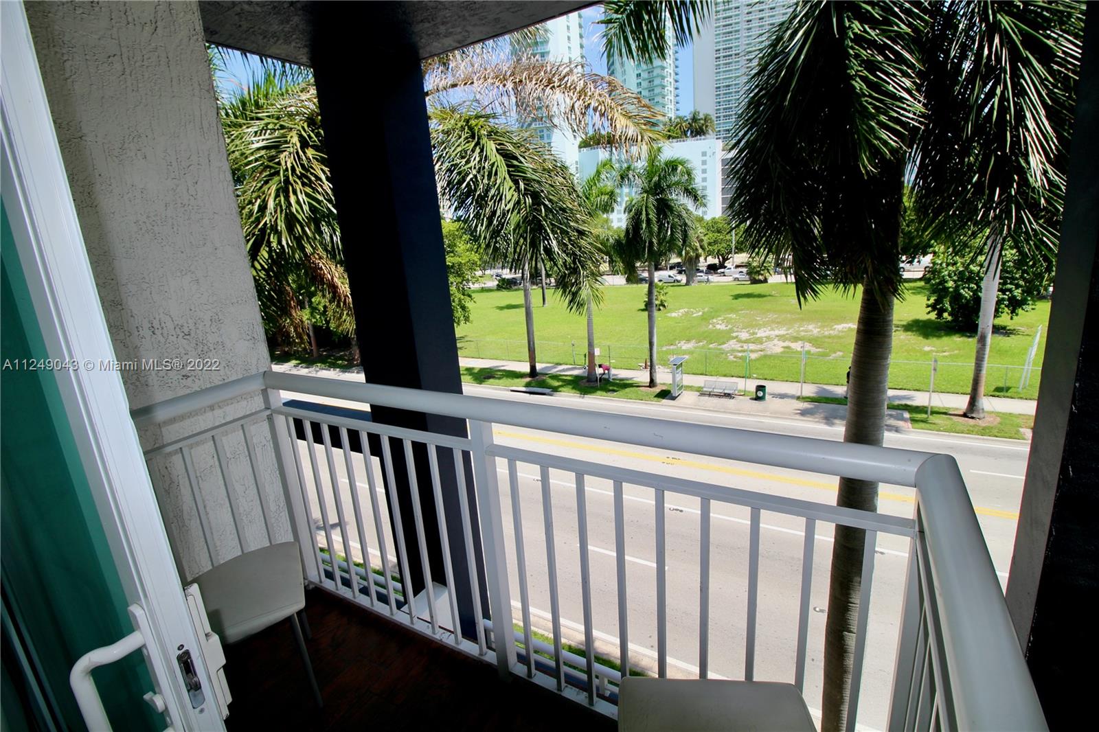 275 Northeast 18th Street, Unit 306 Miami, FL 33132 - Photo 10 of 15 a view of a porch with a table and chairs