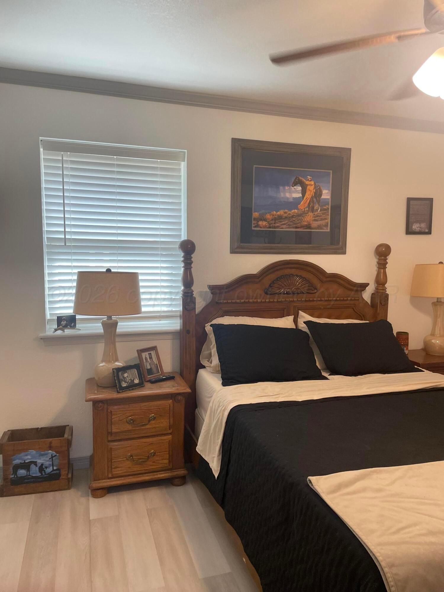 6716 Brookview Way Amarillo, TX 79124 - Photo 12 of 15 a bedroom with a bed and a potted plant