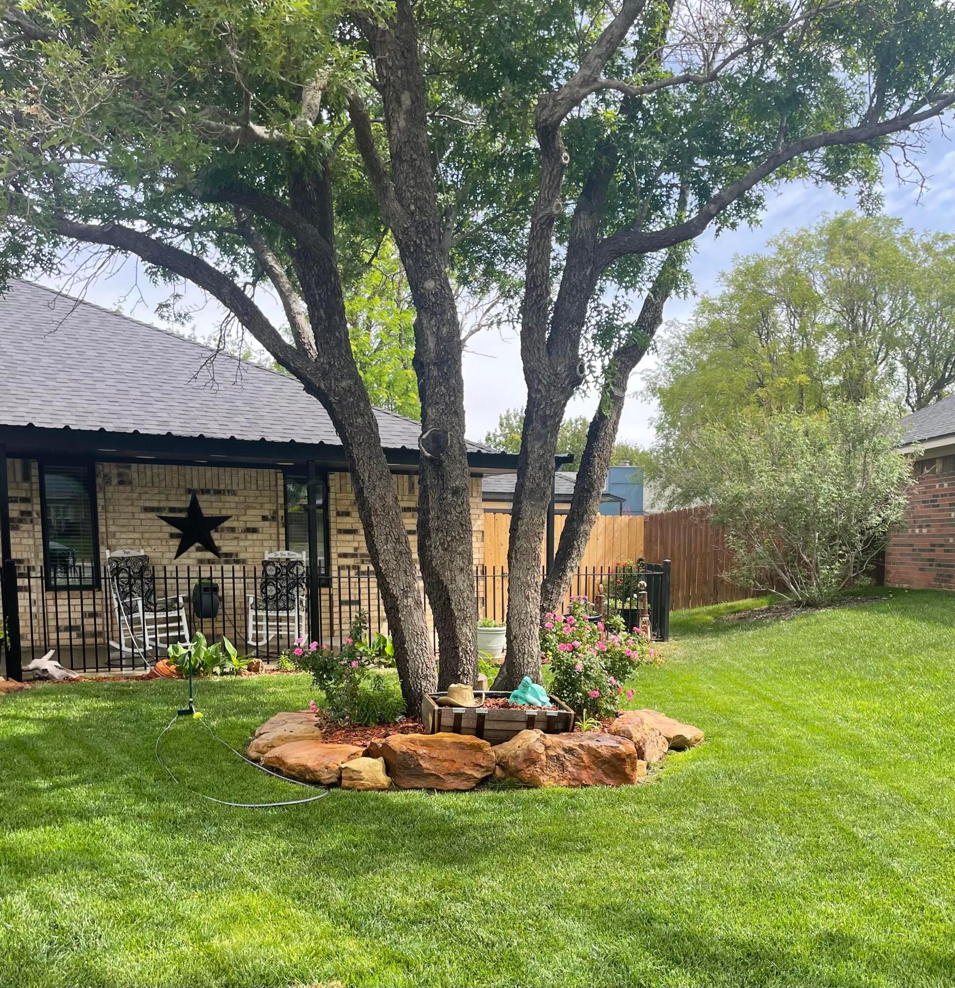 6716 Brookview Way Amarillo, TX 79124 - Photo 2 of 15 a front view of a house with a yard and trees