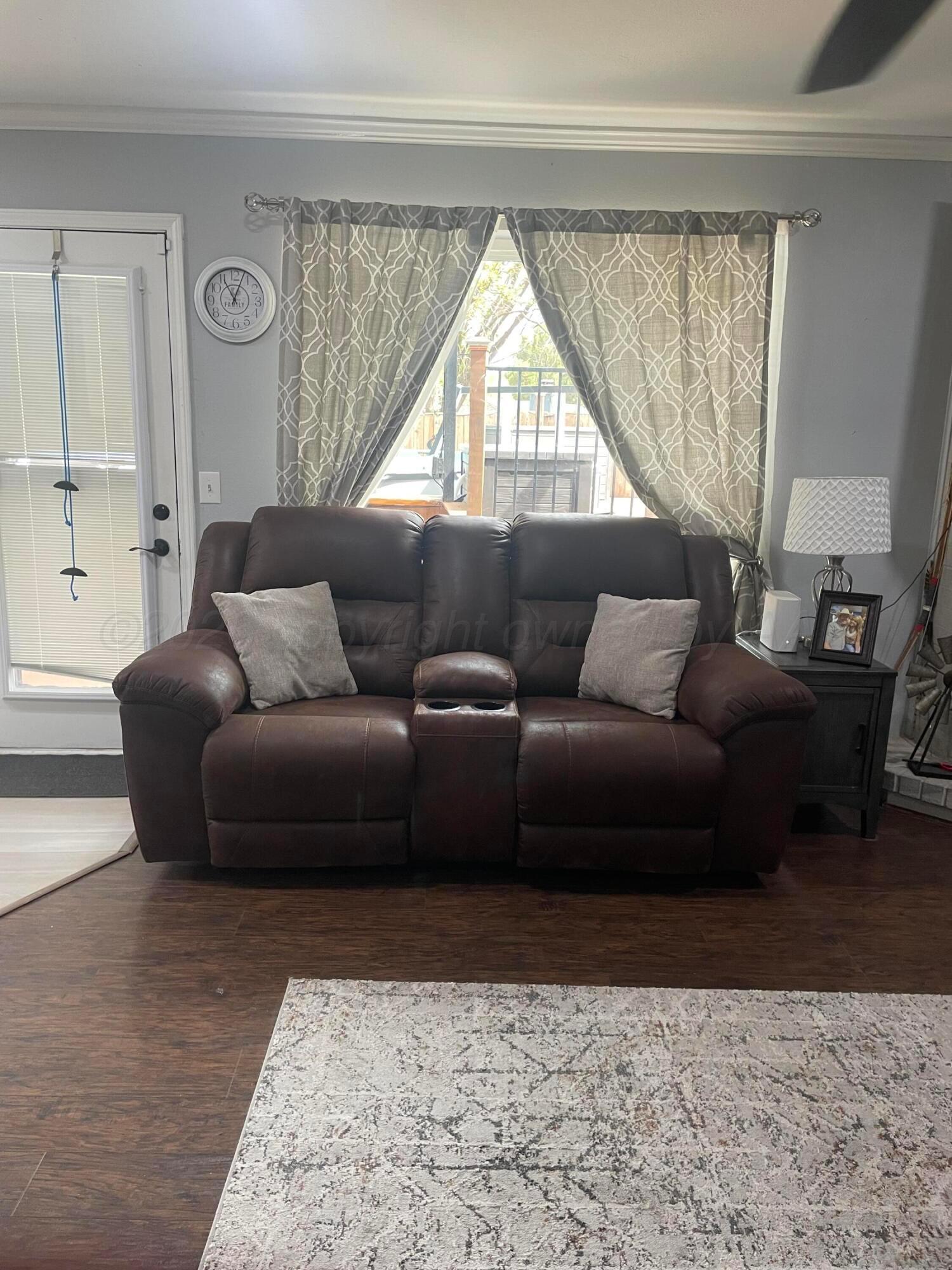 6716 Brookview Way Amarillo, TX 79124 - Photo 4 of 15 a living room with furniture and a window