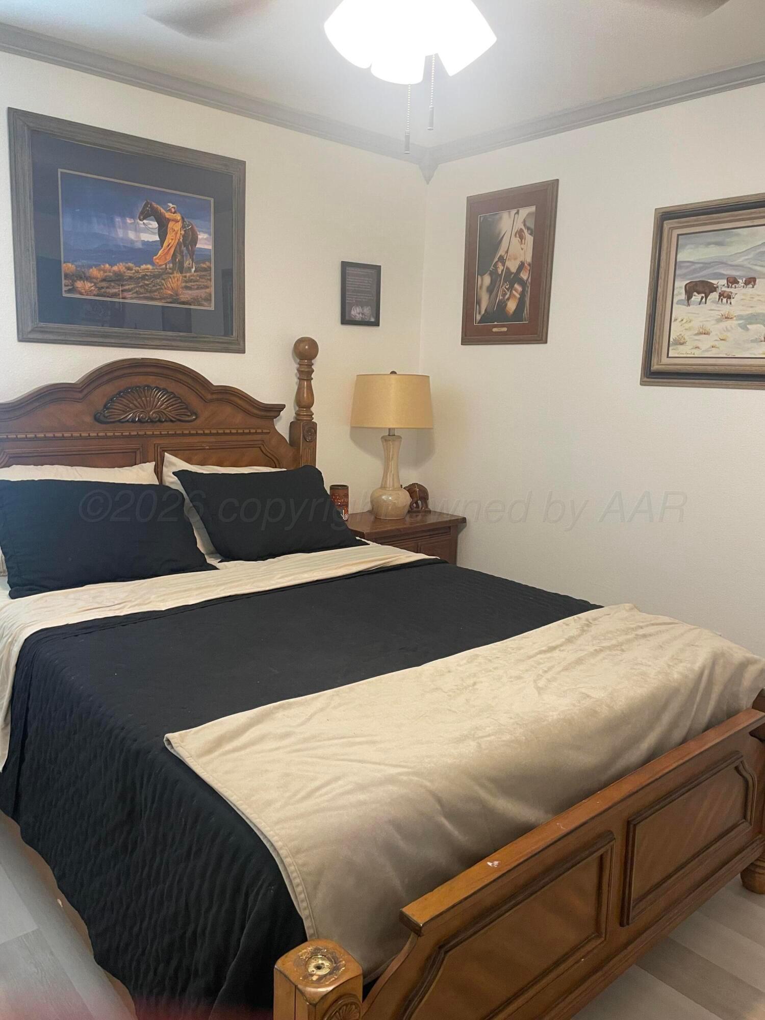 6716 Brookview Way Amarillo, TX 79124 - Photo 7 of 15 a bedroom with a bed and wall painting