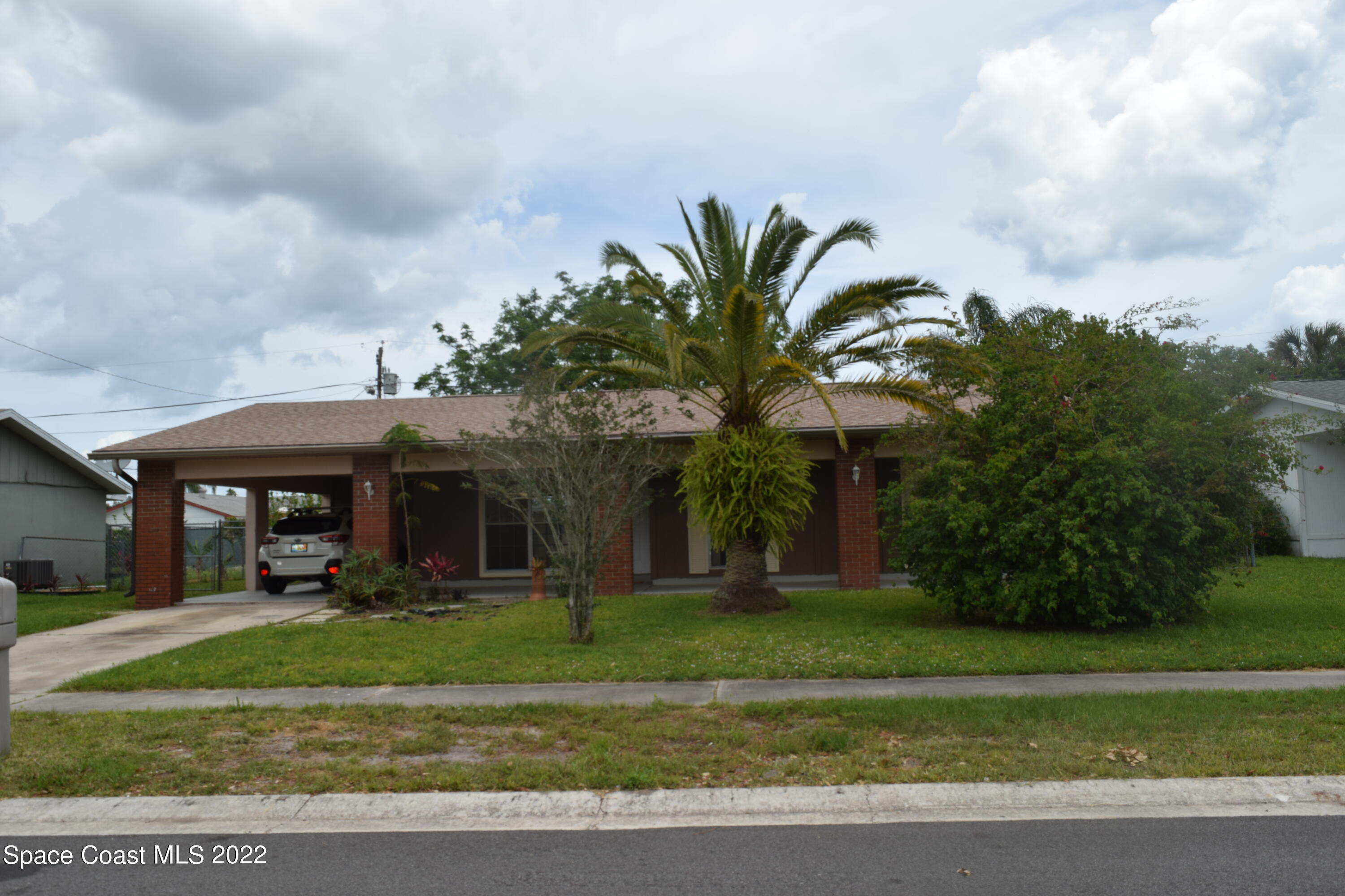 771 Cobblestone Lane Northeast Palm Bay, FL 32905 - Photo 1 of 30 a view of a house with a yard