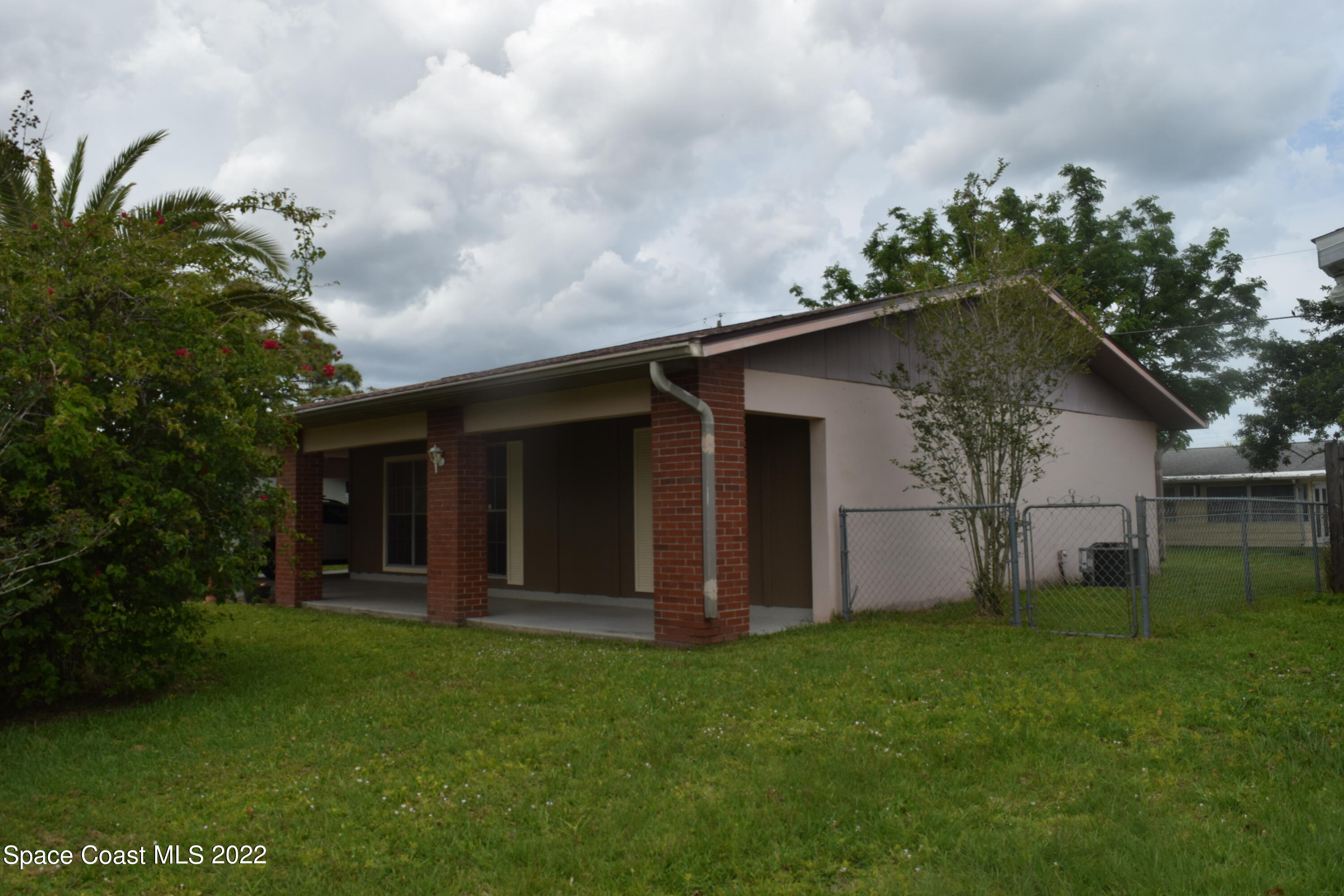 771 Cobblestone Lane Northeast Palm Bay, FL 32905 - Photo 2 of 30 a house with garden in front of it