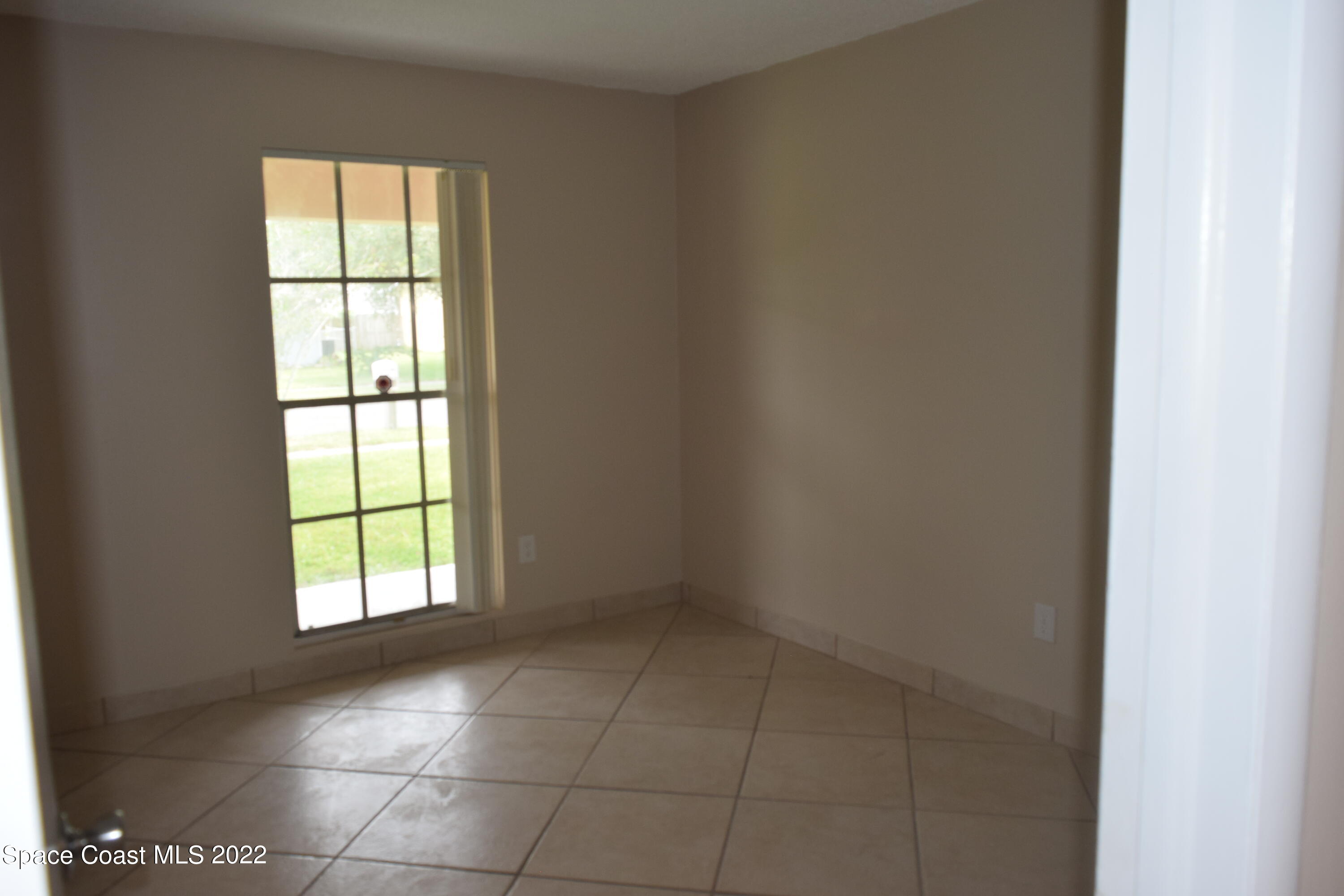 771 Cobblestone Lane Northeast Palm Bay, FL 32905 - Photo 21 of 30 an empty room with windows