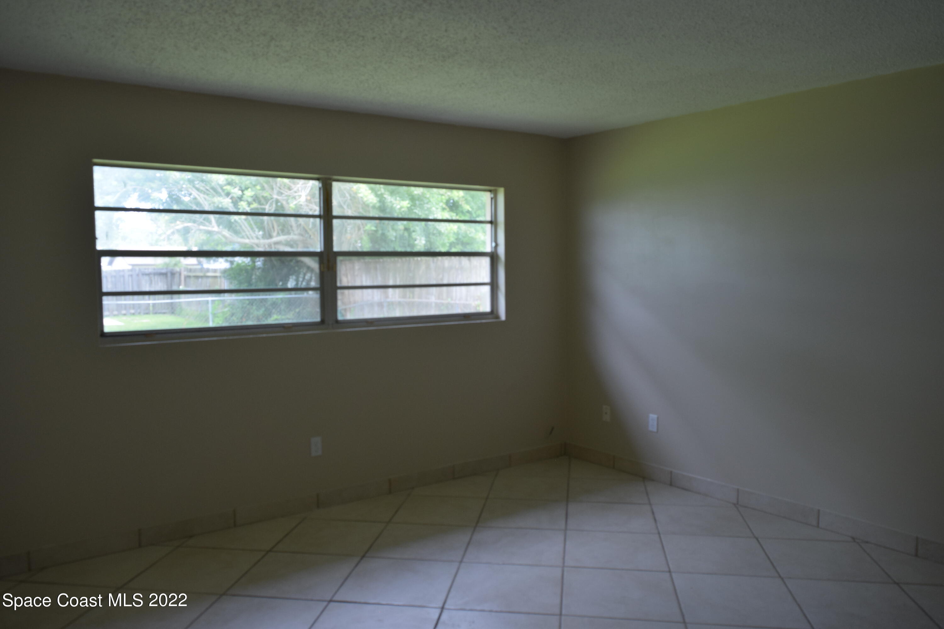 771 Cobblestone Lane Northeast Palm Bay, FL 32905 - Photo 23 of 30 a view of an empty room with a window