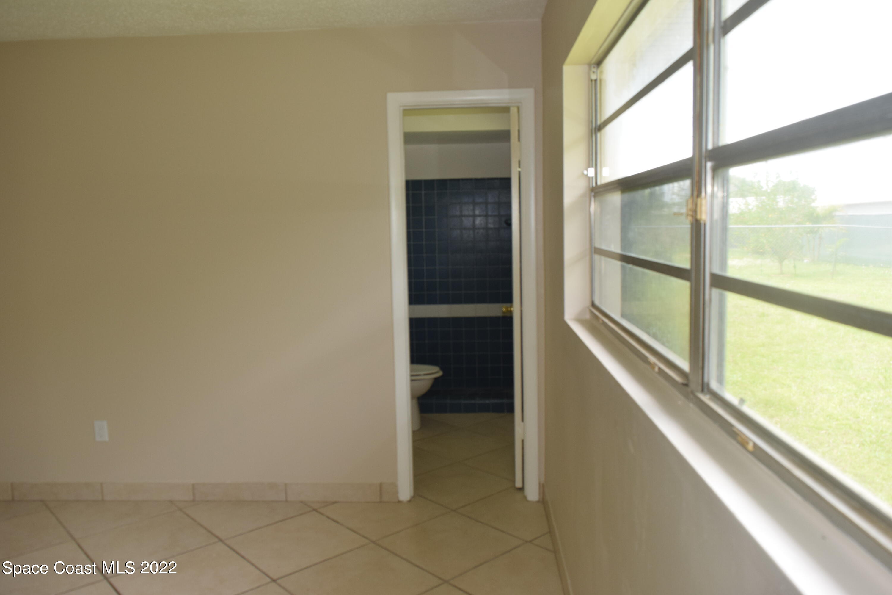 771 Cobblestone Lane Northeast Palm Bay, FL 32905 - Photo 25 of 30 a view of walk in closet with clothes