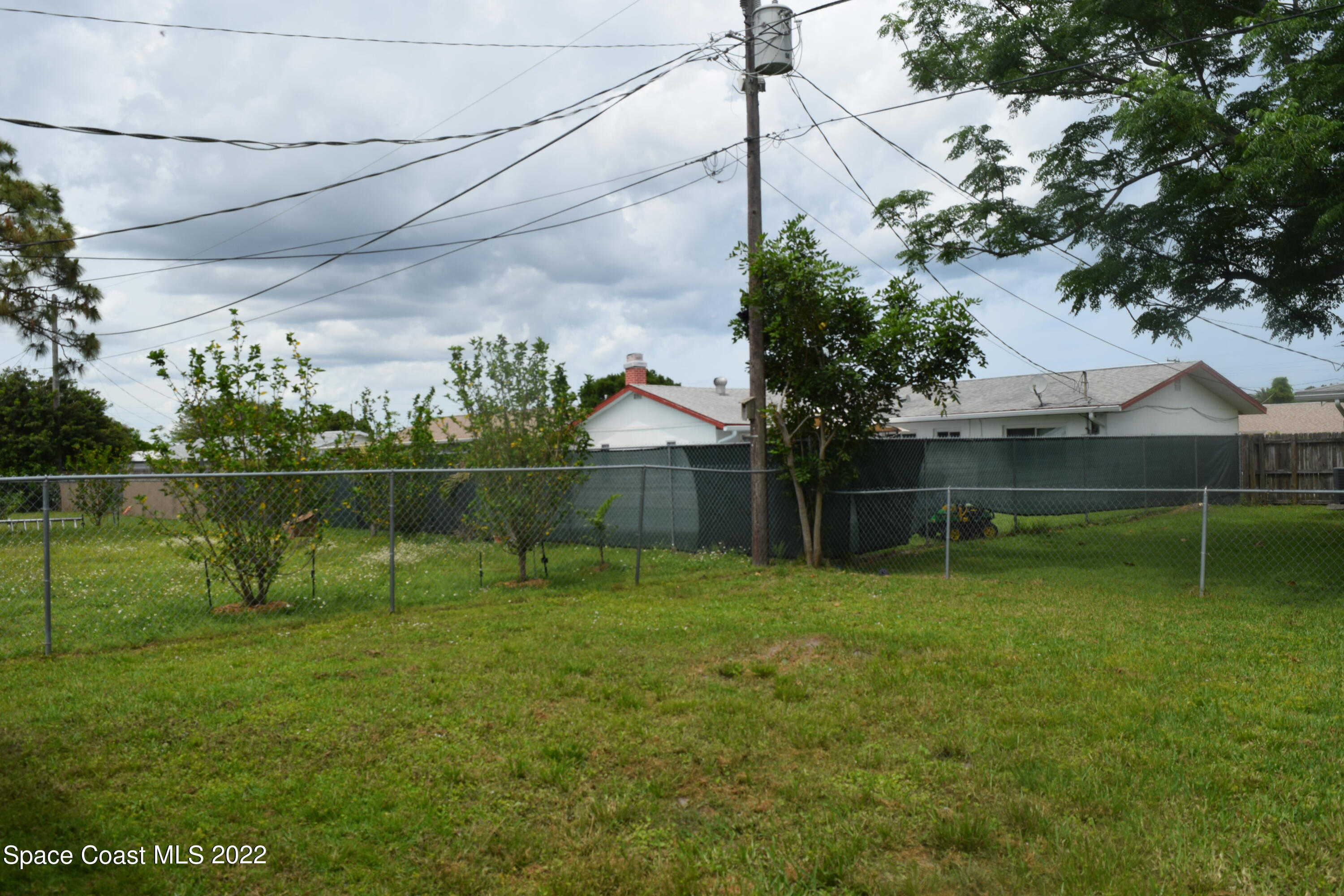 771 Cobblestone Lane Northeast Palm Bay, FL 32905 - Photo 28 of 30 a backyard of a house with lots of green space