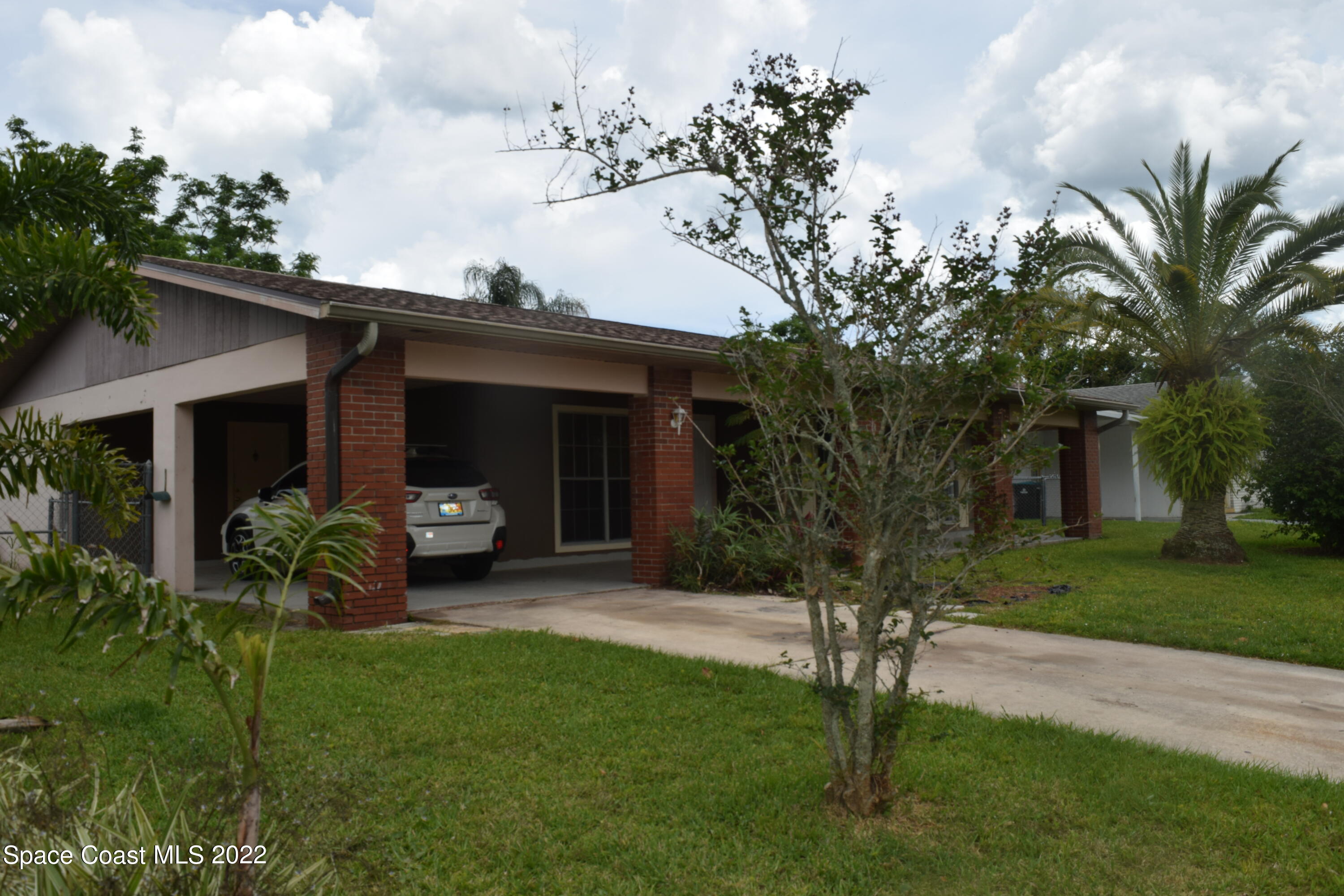 771 Cobblestone Lane Northeast Palm Bay, FL 32905 - Photo 3 of 30 a house view with a garden space