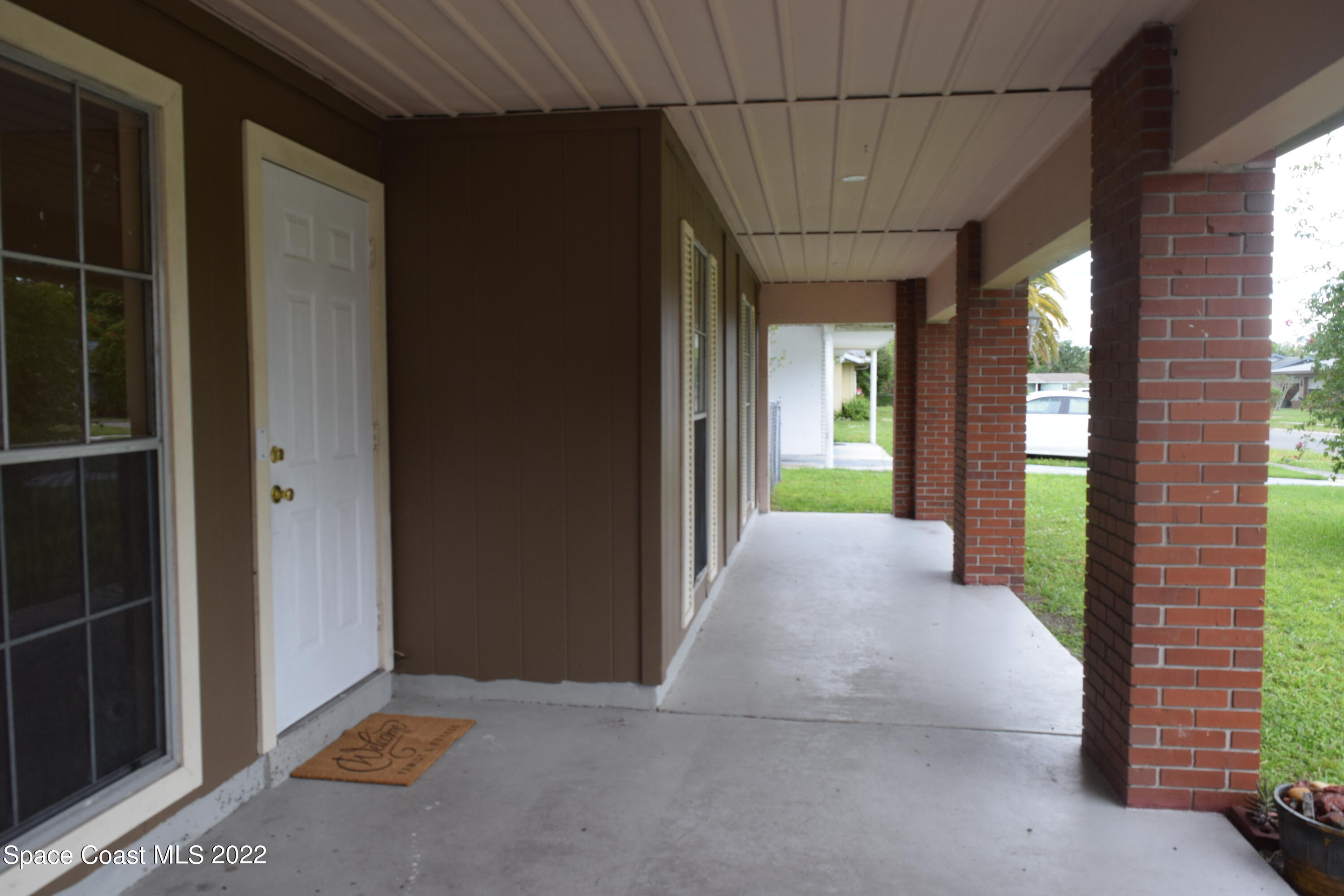 771 Cobblestone Lane Northeast Palm Bay, FL 32905 - Photo 5 of 30 a view of a room with a large window and wooden door