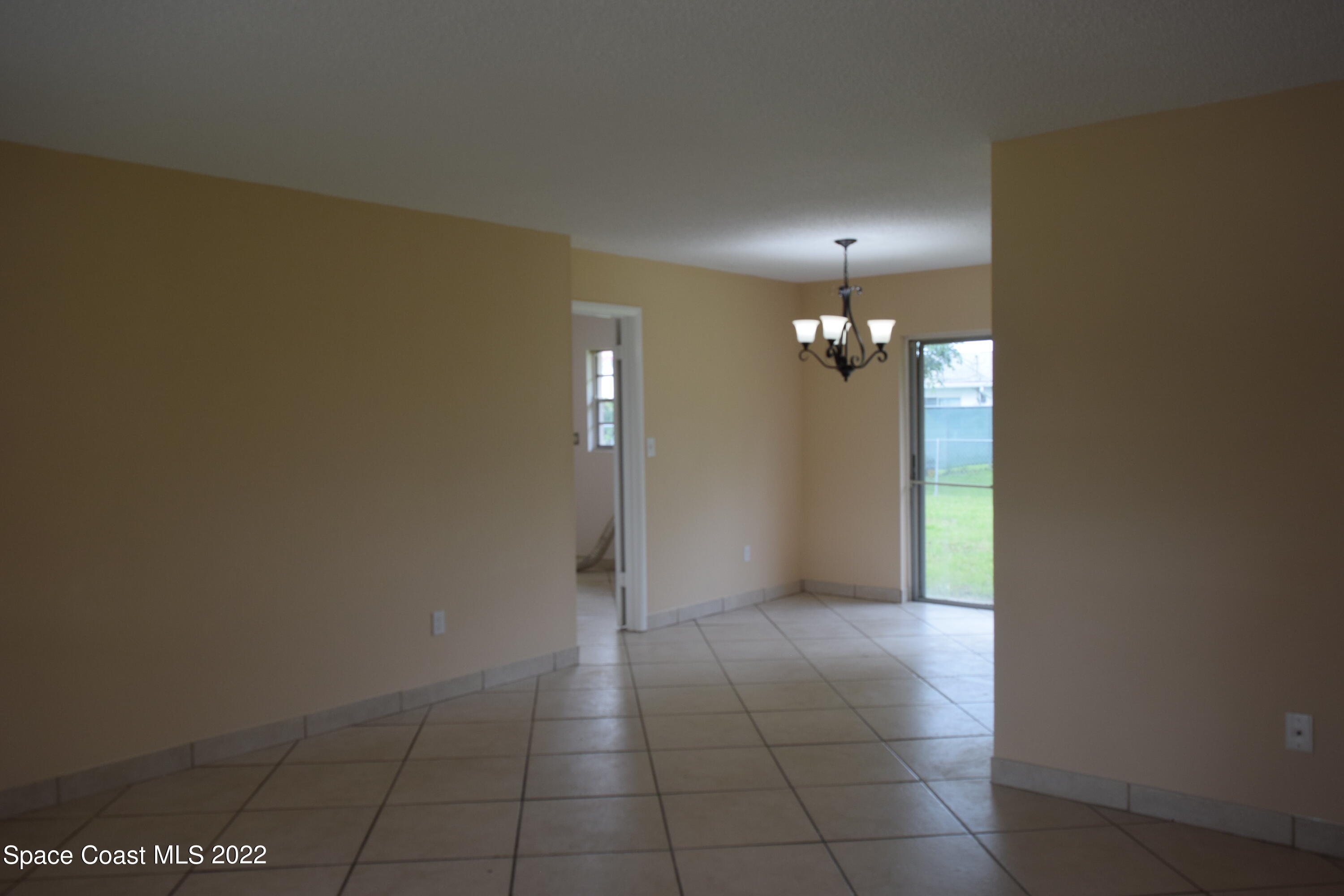 771 Cobblestone Lane Northeast Palm Bay, FL 32905 - Photo 6 of 30 an empty room with an entryway