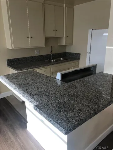 a kitchen with white cabinets