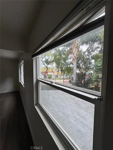 a view of a room with wooden floor