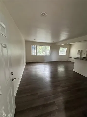 a view of wooden floor and windows in a room