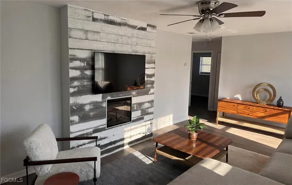a living room with furniture and a flat screen tv
