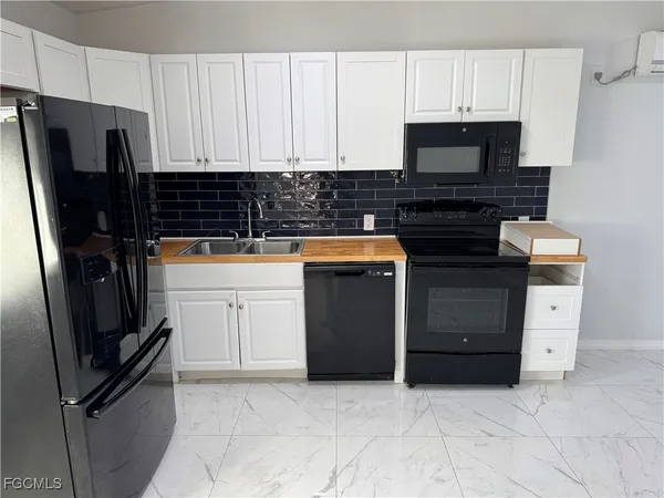 a kitchen with a refrigerator and a stove