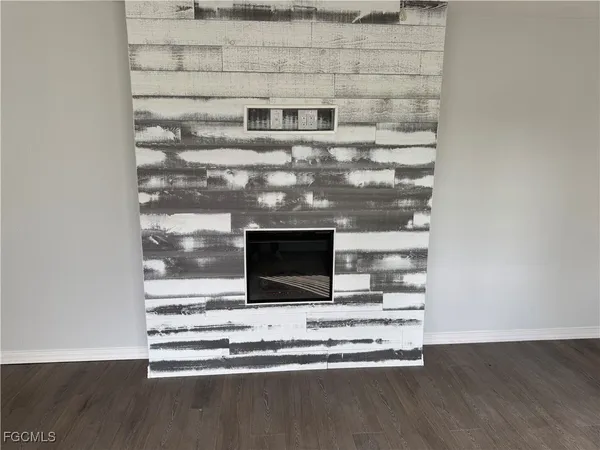 a view of fireplace with wooden floor