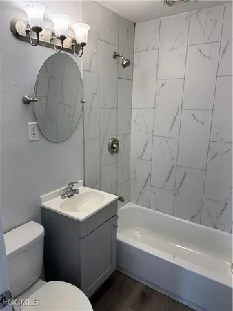 a bathroom with a toilet a sink and bathtub