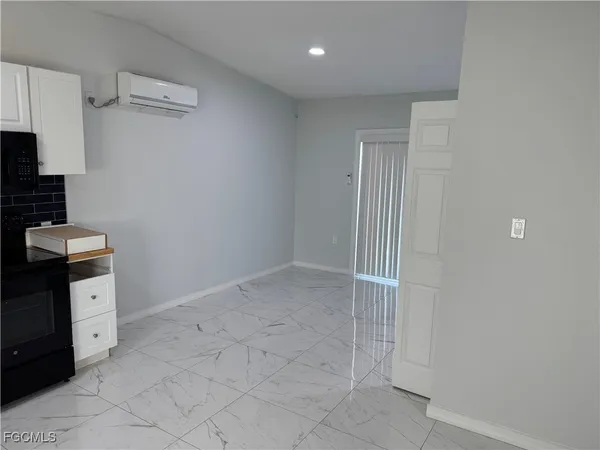 a kitchen with cabinets and window