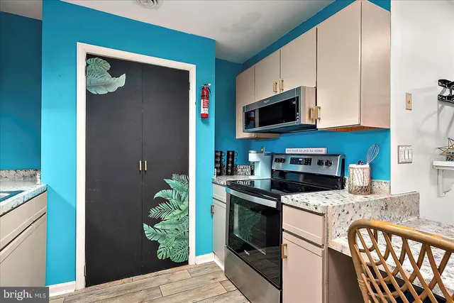 a kitchen with stainless steel appliances granite countertop a stove a microwave and a refrigerator