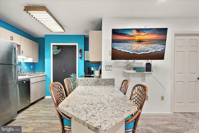 a dining room with furniture and chandelier