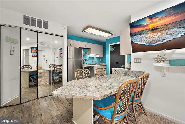 a view of a dining room with furniture and a floor to ceiling window