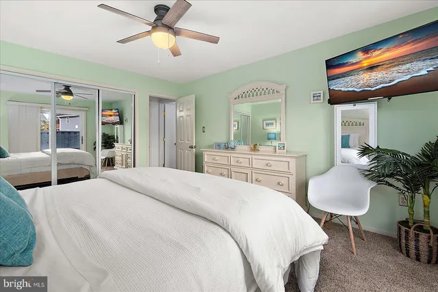 a bedroom with a bed and ceiling fan