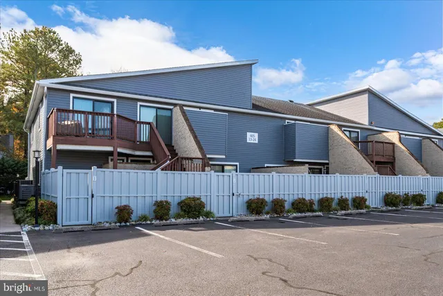 a view of a house with wooden fence