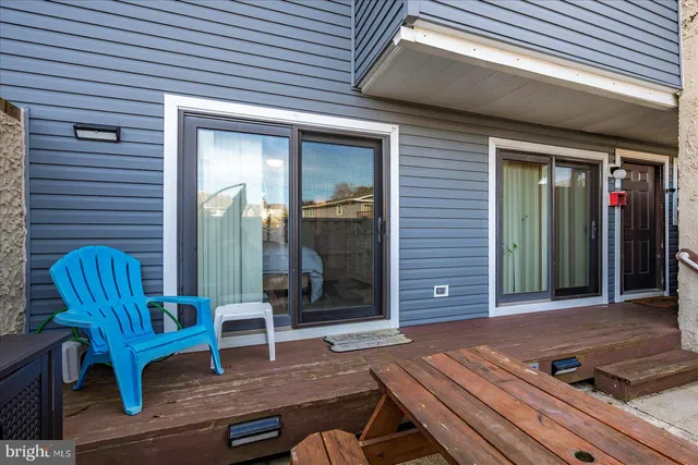 a backyard of a house with barbeque oven table and chairs