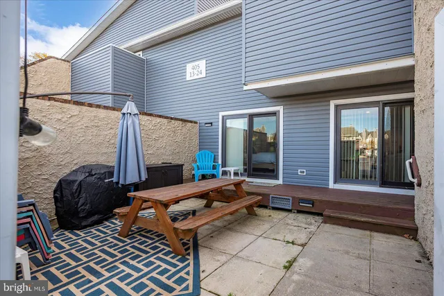 a backyard of a house with barbeque oven table and chairs
